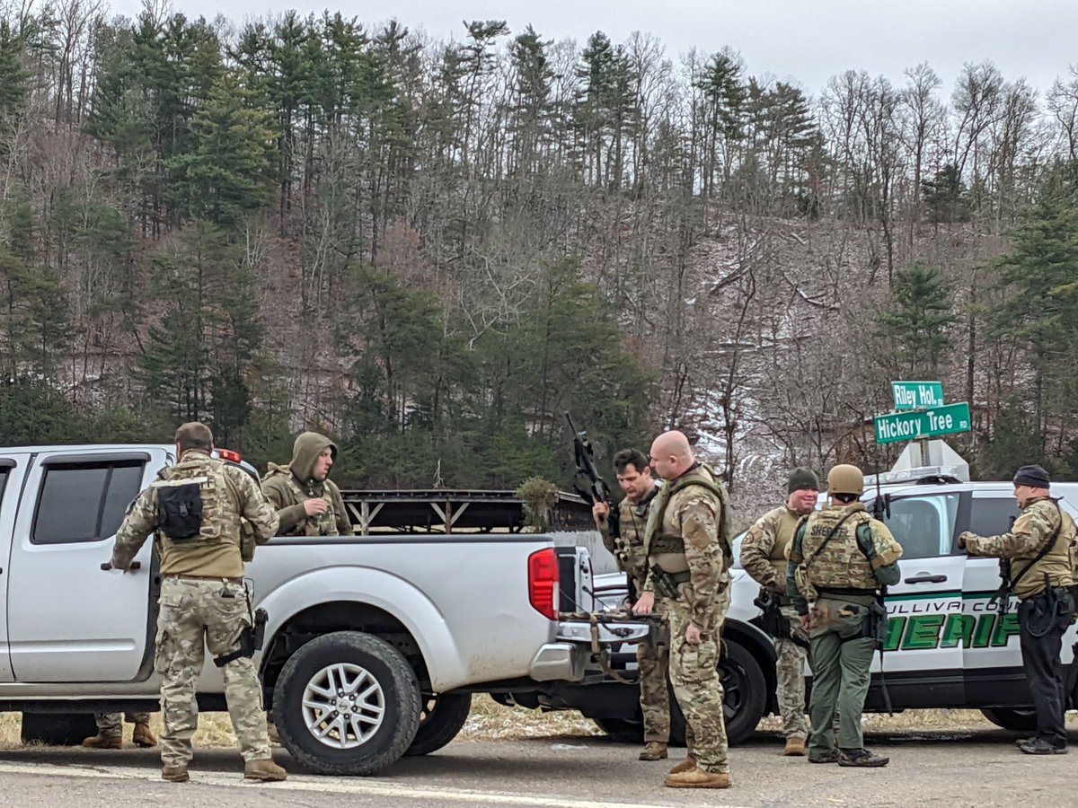 SWAT team members of the Sullivan County Sheriff's Office emerge from Riley Hollow Rd just before 10 a.m. Friday morning following a standoff with a person of interest following the shooting of a deputy sometime after midnight