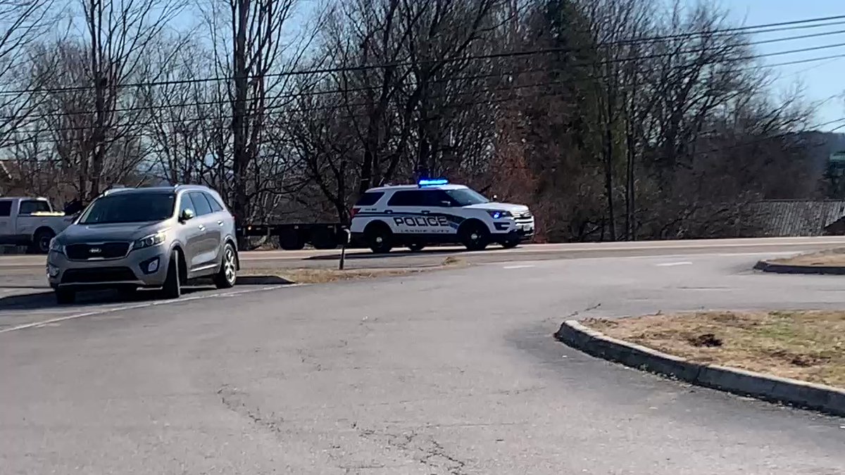 Several police and sheriff's vehicles driving by @LCSOTN with their lights on ahead of the service for Sgt. Chris Jenkins