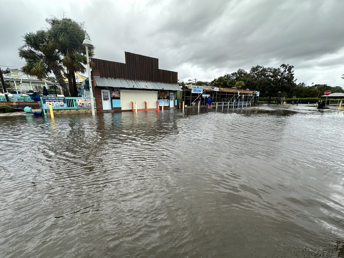 Scene of a boat knocked partially on its side and some considerable street flooding after Hurricane Debby lashed Gulfport